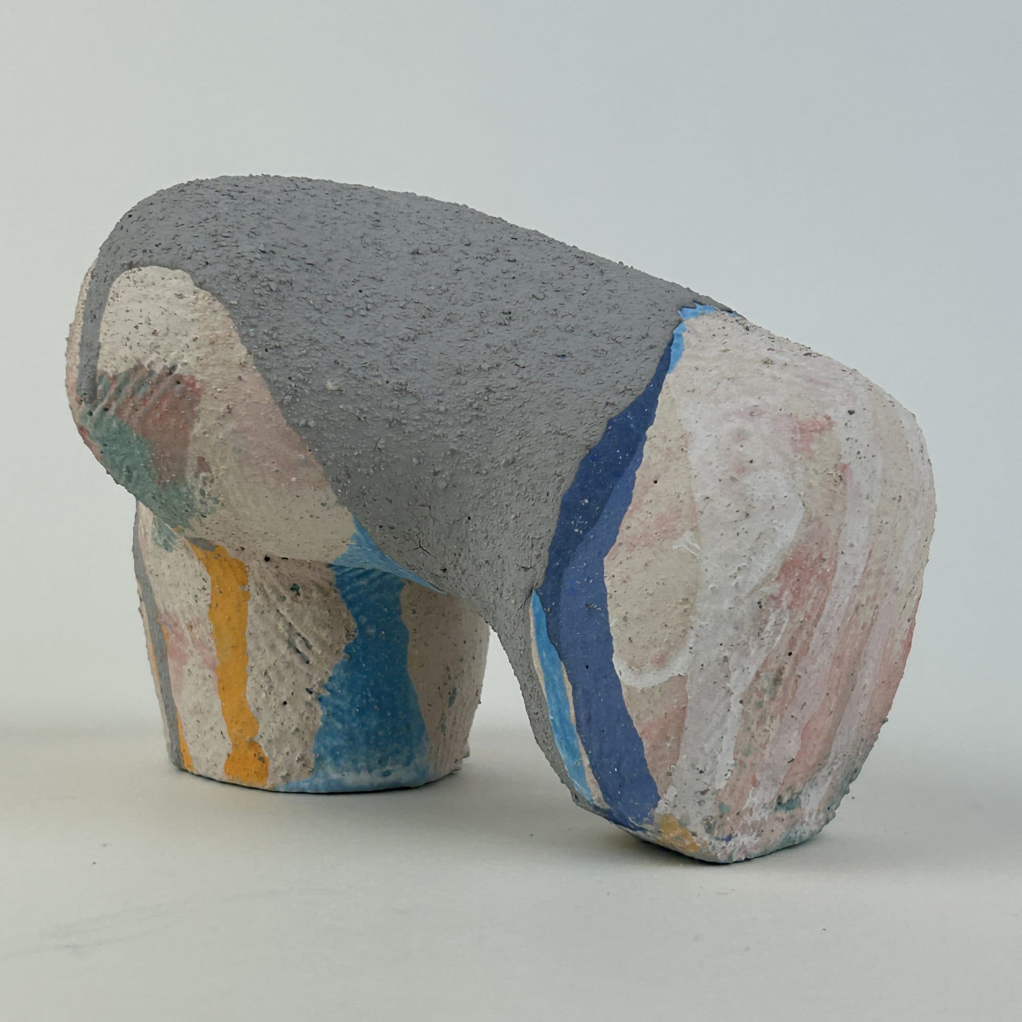 Low grey and white ceramic arch banded with blue, yellow and coral glaze.