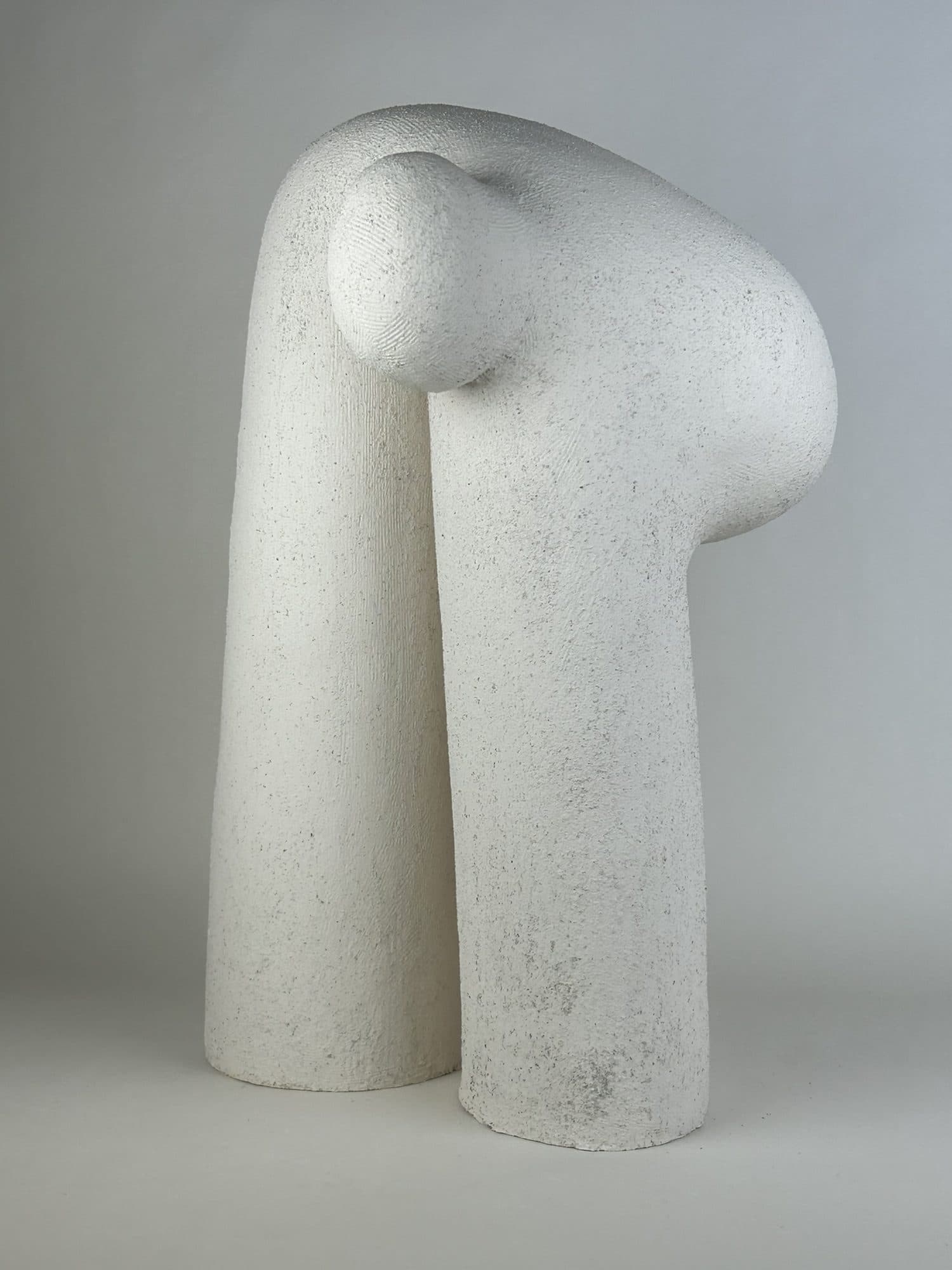 White ceramic column form with a small knob set at the shoulder.